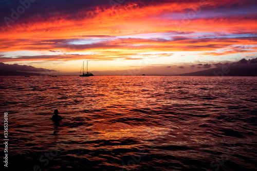 Orange and Purple Sunset over Sea with Islands in Distance