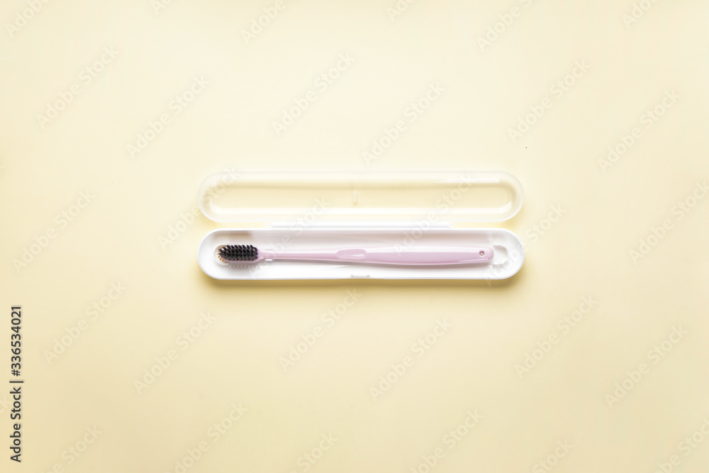 Toothbrush in a case on a yellow background, flat lay. Toothbrush in a case on a yellow background, flat lay.