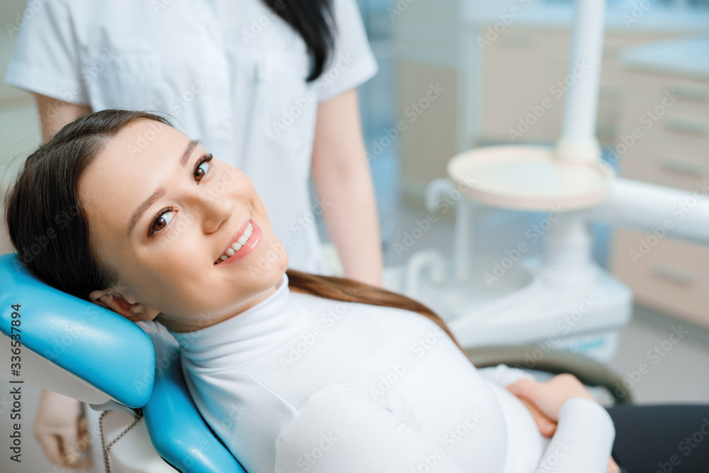 Patient in dental chair. Beautiful young woman having dental treatment at dentist's office. Healthy teeth, dental care concept. Patient in dental chair. Beautiful young woman having dental treatment at dentist's office. Healthy teeth, dental care concept.