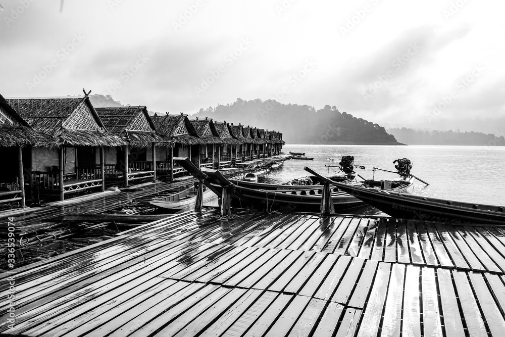 Obraz premium Rainy day on pileworks with long tail boats at Khao Sok Lake, Thailand