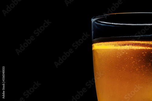 Glass of beer on a dark background. Close-up photo.