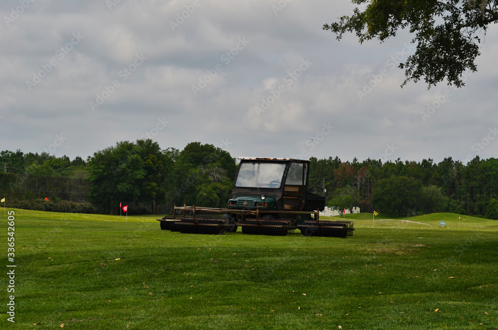 Golf Driving Range with Flag and Golf Cart with Machine that Collects Golf Balls
