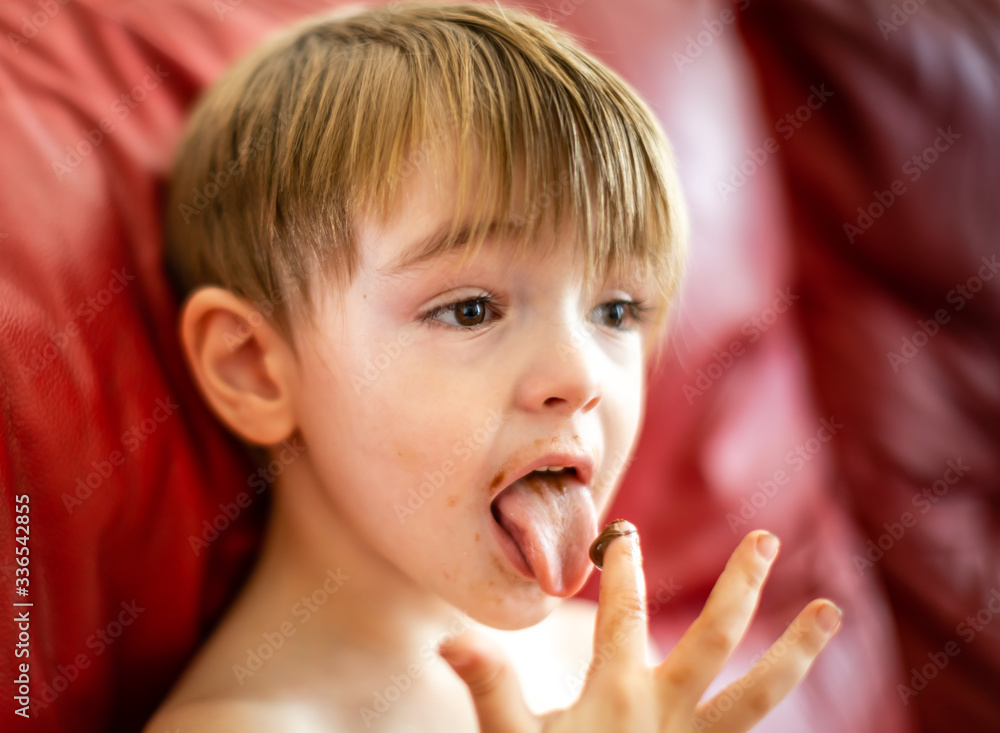 little kid tasting a snack sweet food very messy little kid tasting a snack sweet food very messy
