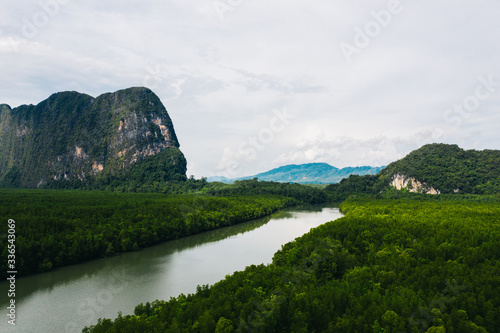 Aerial scenery view of mangroves forest, river canals and mountains. Bird's eye view of beautiful panoramic nature landscape of tropical water jungle on Ao Phang Nga bay National Park, Thailand