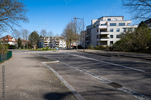 Fototapeta Naklejka Na Ścianę i Meble -  Empty French street during Coronavirus Covid-19 pandemic outbreak with tall luxury apartment houses near Orangerie park
