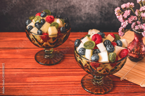 Melon on wooden table with black background
