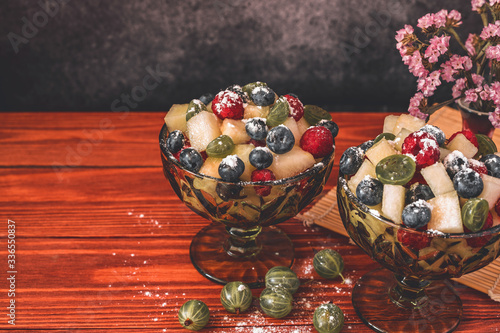 Melon on wooden table with black background