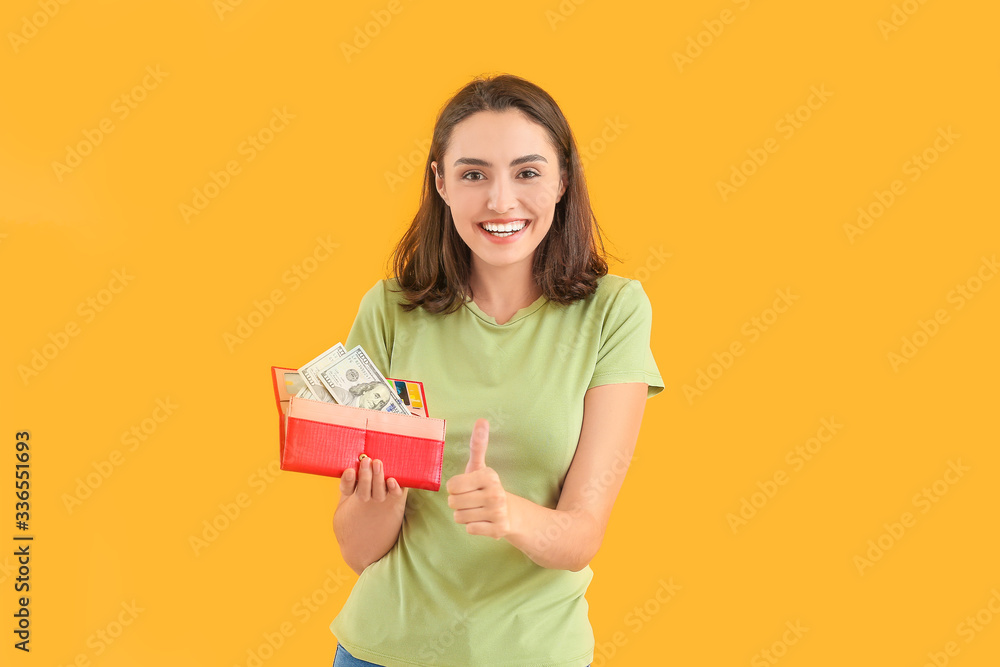 Young woman with wallet on color background Young woman with wallet on color background