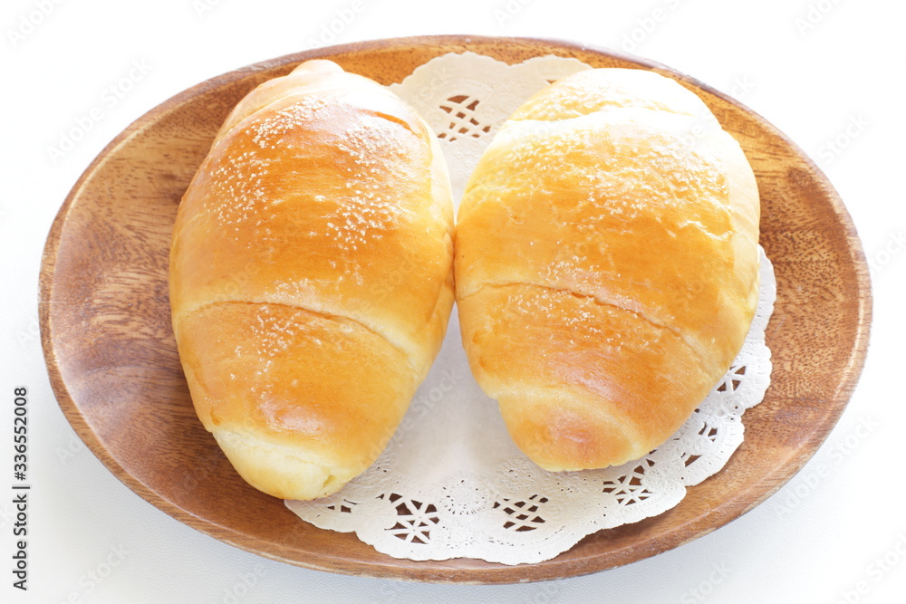Homemade butter roll bread on wooden plate Homemade butter roll bread on wooden plate