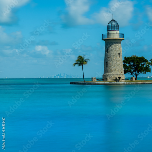 Boca Chita Lighthouse Reflecting in Blue Water © kellyvandellen