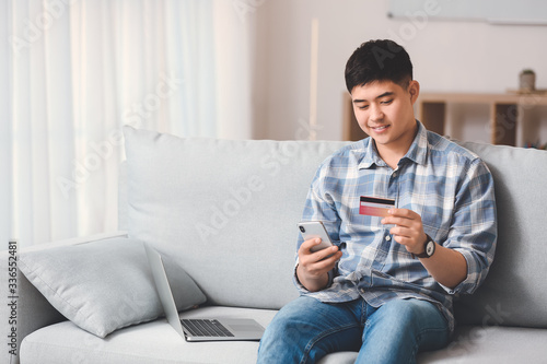 Asian man shopping online a...