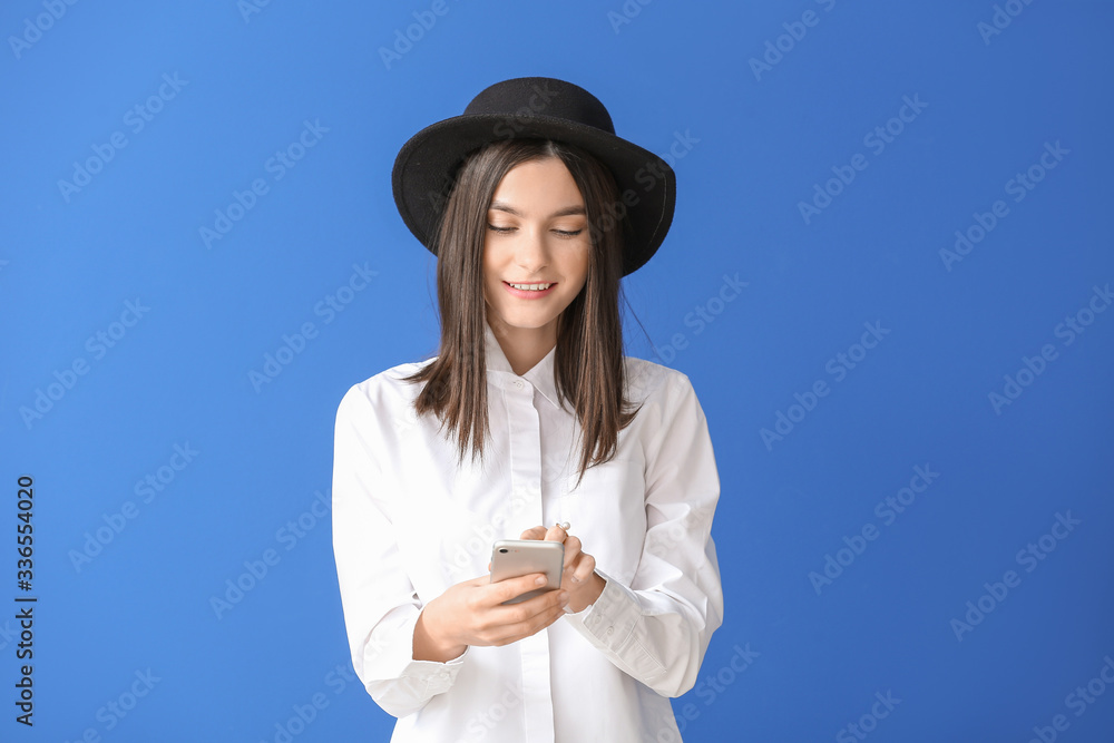 Beautiful young woman with mobile phone on color background Beautiful young woman with mobile phone on color background