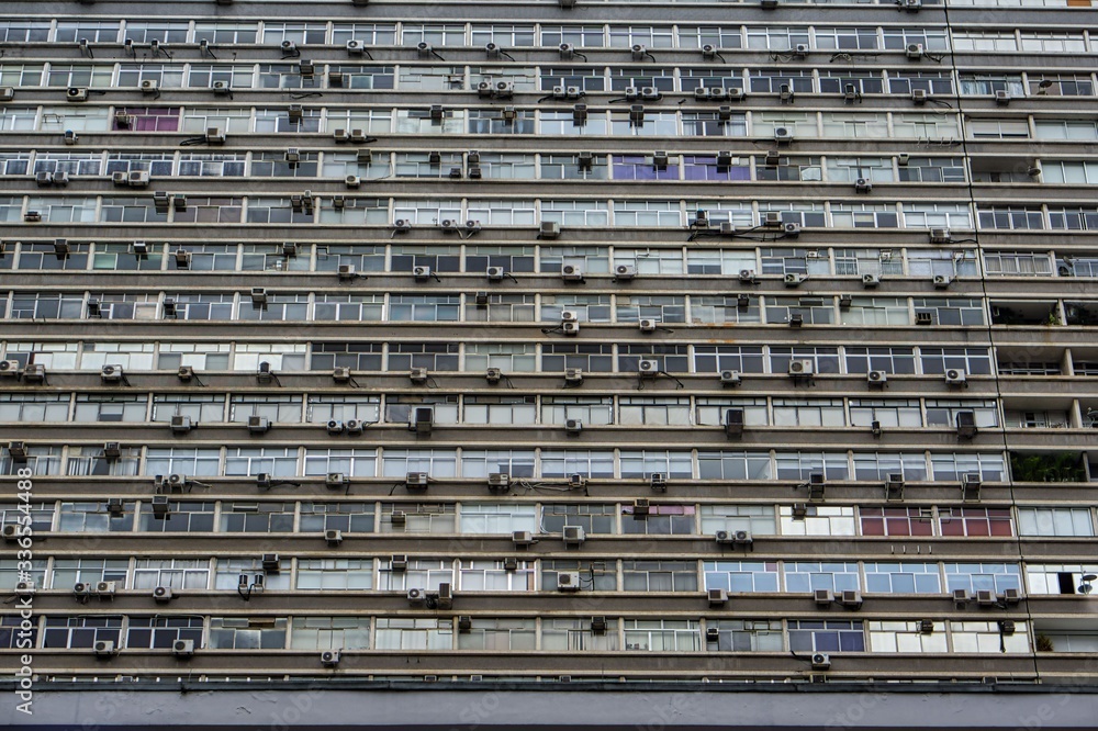 Close-up front view of a run down grey mass apartment block building close to the famous Paulista street in Sao Paulo, Brazil. Close-up front view of a run down grey mass apartment block building close to the famous Paulista street in Sao Paulo, Brazil.