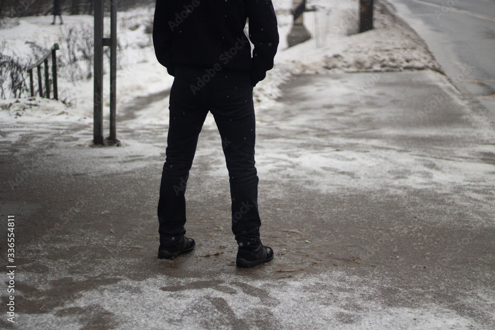 Obraz premium A man is waiting for a bus.