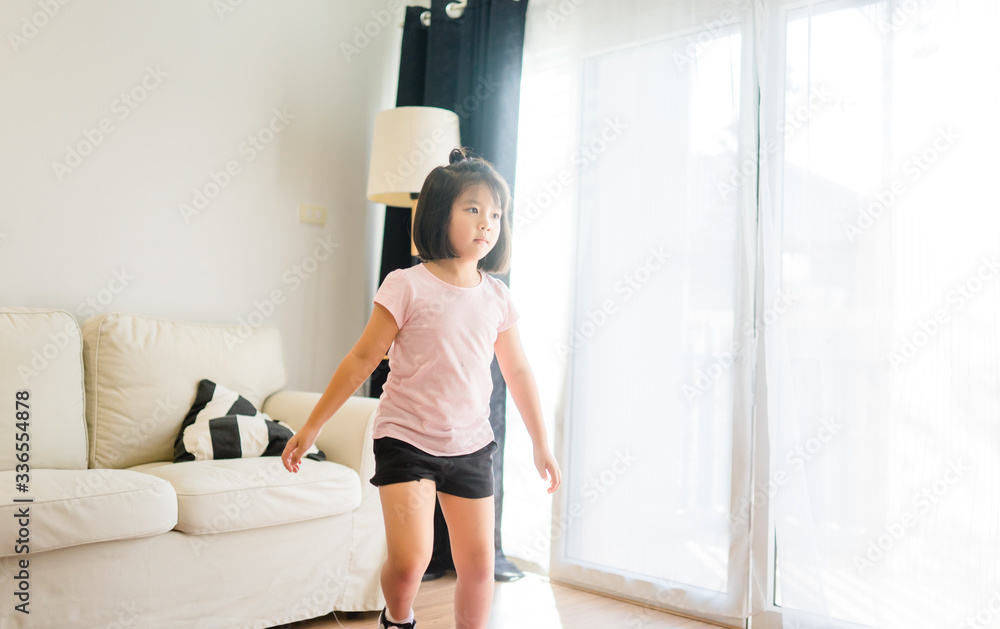Video streaming Stay at home.home fitness workout class live streaming online.Asian little kid girl training game aerobic dance exercises watching videos on a smart tv in the living room at home. Video streaming Stay at home.home fitness workout class live streaming online.Asian little kid girl training game aerobic dance exercises watching videos on a smart tv in the living room at home.