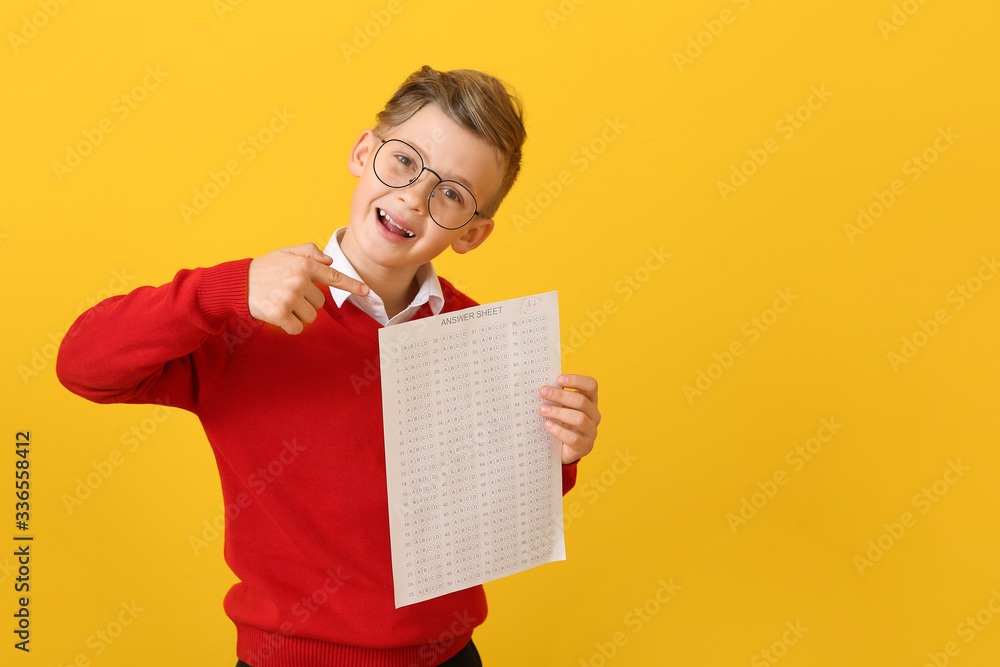 Pupil with answer sheet for school test on color background Pupil with answer sheet for school test on color background