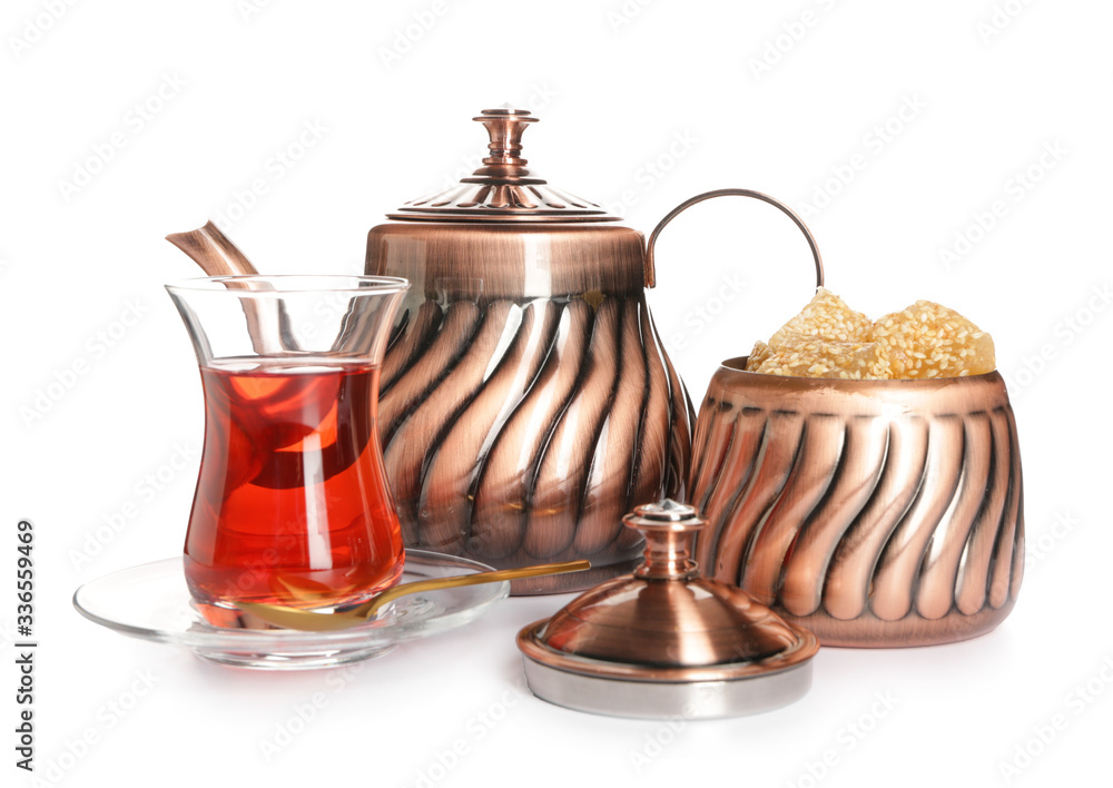 Tasty Turkish tea with sweets on white background