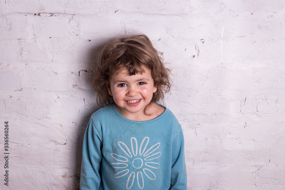 Girl on the white wall background smiling highly expressional Girl on the white wall background smiling highly expressional
