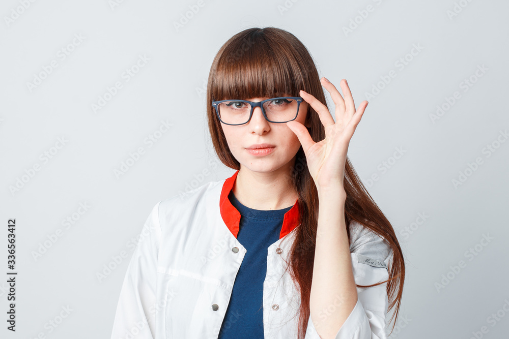 Smiling happy doctor pointing on blue background Smiling happy doctor pointing on blue background