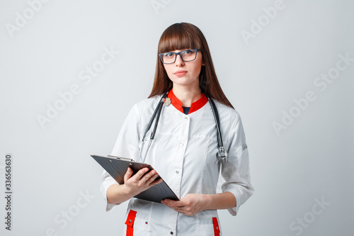 Smiling happy doctor pointing on blue background photo