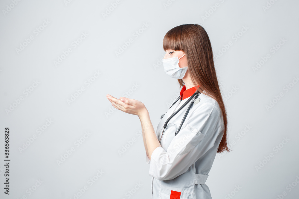 Young doctor in a coat and mask on a white background Young doctor in a coat and mask on a white background