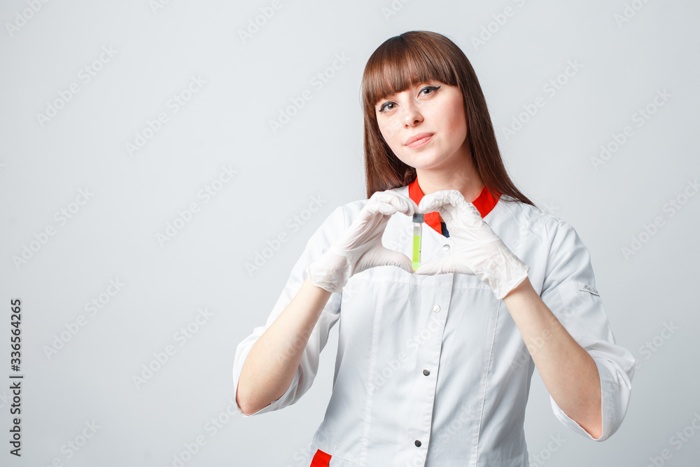 Female researcher or scientist using laboratory equipment for syringe in sterile clothing holding the vaccine Female researcher or scientist using laboratory equipment for syringe in sterile clothing holding the vaccine