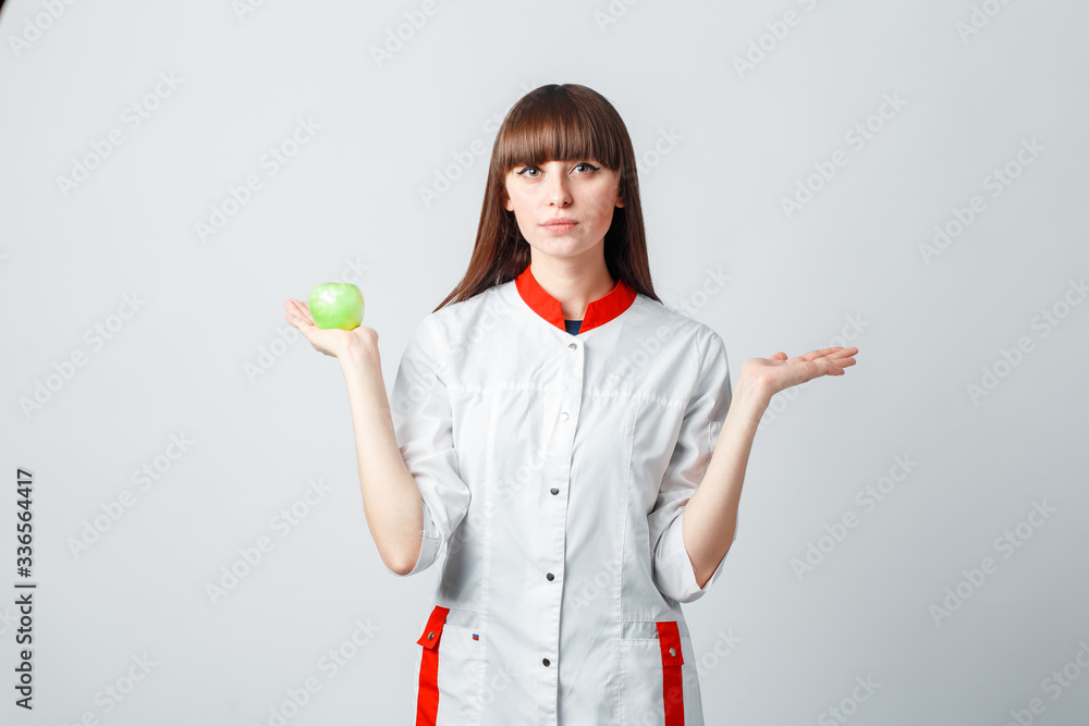 Female researcher or scientist using laboratory equipment for syringe in sterile clothing holding the apple Female researcher or scientist using laboratory equipment for syringe in sterile clothing holding the apple