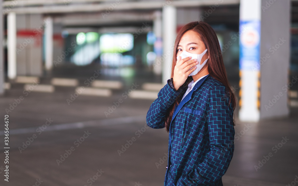 Closeup image of an asian woman wearing protective face mask for Healthcare and Covid-19 or 2020 virus concept
