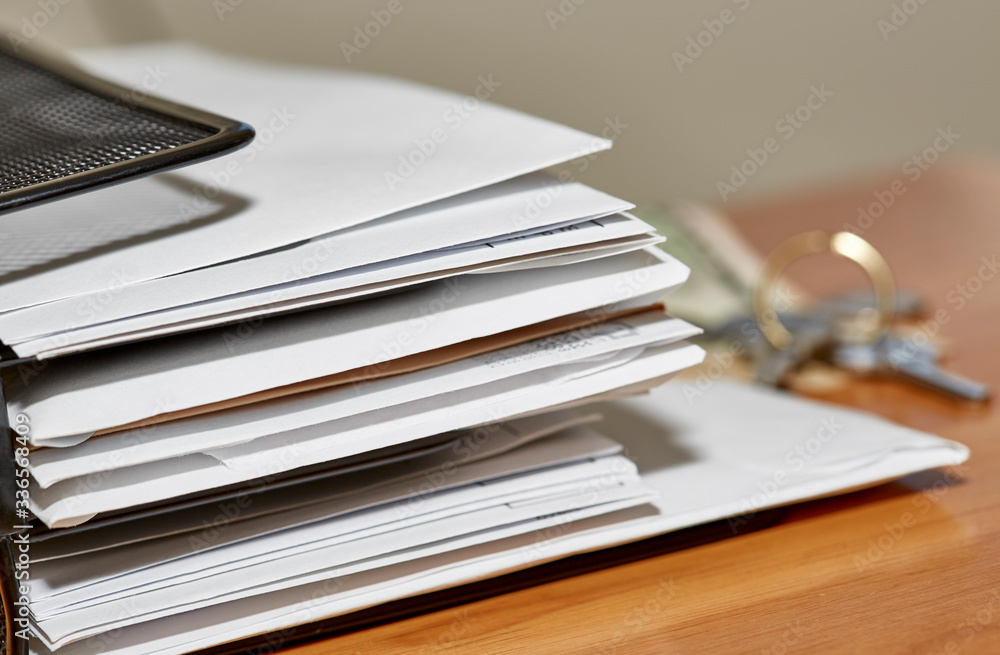 Paper Envelopes with Keys and Money on a Desk Paper Envelopes with Keys and Money on a Desk