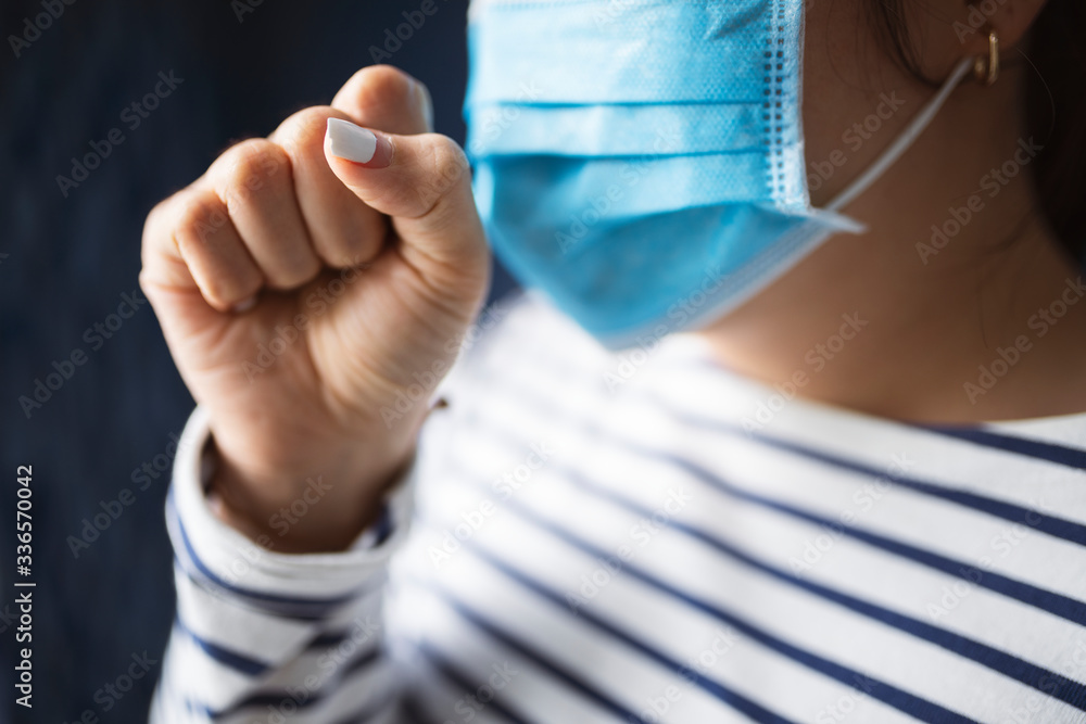 Sick woman in a mask coughing in public during coronavirus pandemic Sick woman in a mask coughing in public during coronavirus pandemic