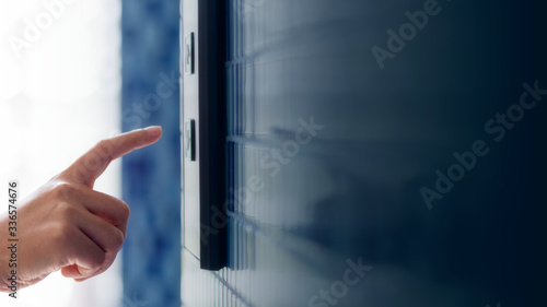 Woman pressing an elevator button