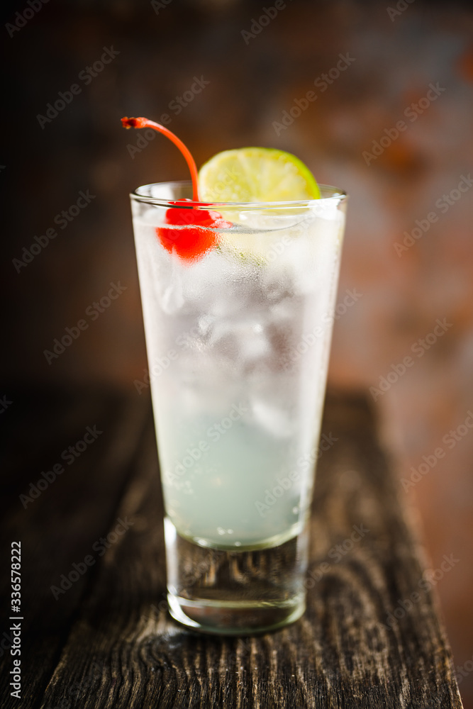 Rum collins cocktail (variation of traditional Tom collins). Selective focus. Shallow depth of field. Rum collins cocktail (variation of traditional Tom collins). Selective focus. Shallow depth of field.