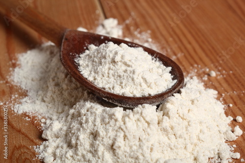 Wheat flour on wooden spoon