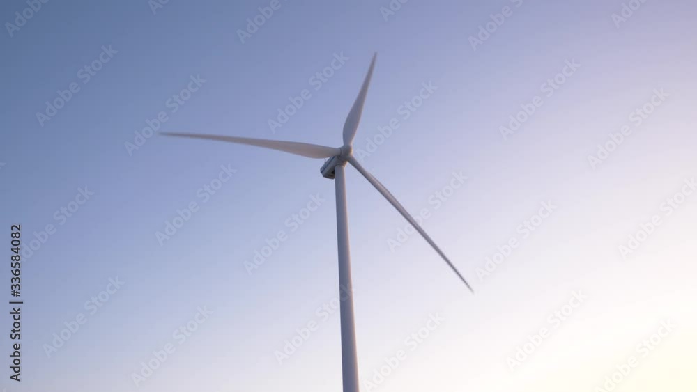 Close up shot of wind turbine slowly spinning during a sunset/sunrise. Concept of clean and green energy. Close up shot of wind turbine slowly spinning during a sunset/sunrise. Concept of clean and green energy.