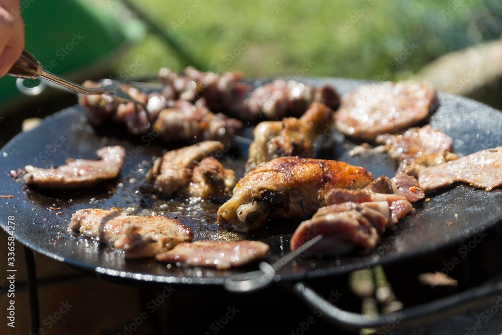 meat cooking on oil plate
