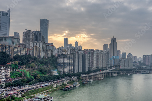 Sunset over residence buildings by Jialing river in Chongqing, China