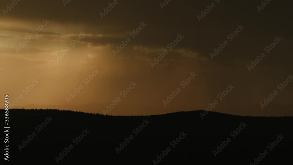 Beautiful Rain Clouds Rolling Over The Mountains During Sunset - Time Lapse Beautiful Rain Clouds Rolling Over The Mountains During Sunset - Time Lapse