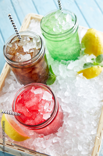 Refreshed Mojito cocktails with lime mint and strawberry on the bar desk. This is summer exotic colorful cocktails