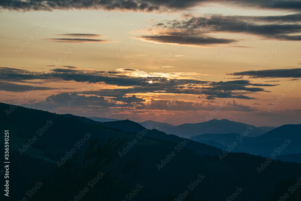 Beautiful Carpathians, mountains in clouds, waterfall, close-up, the sunsets beautifully over the mountains