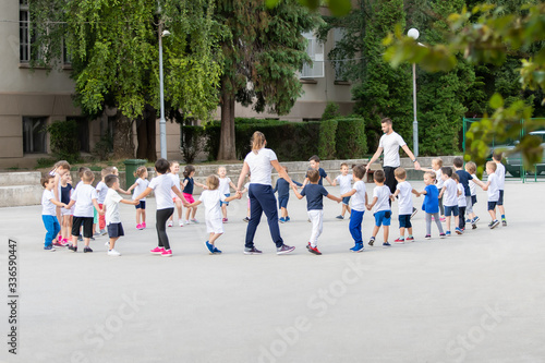 Group of children warming up and preparing for the main part of lesson.  Sport school © cirkoglu