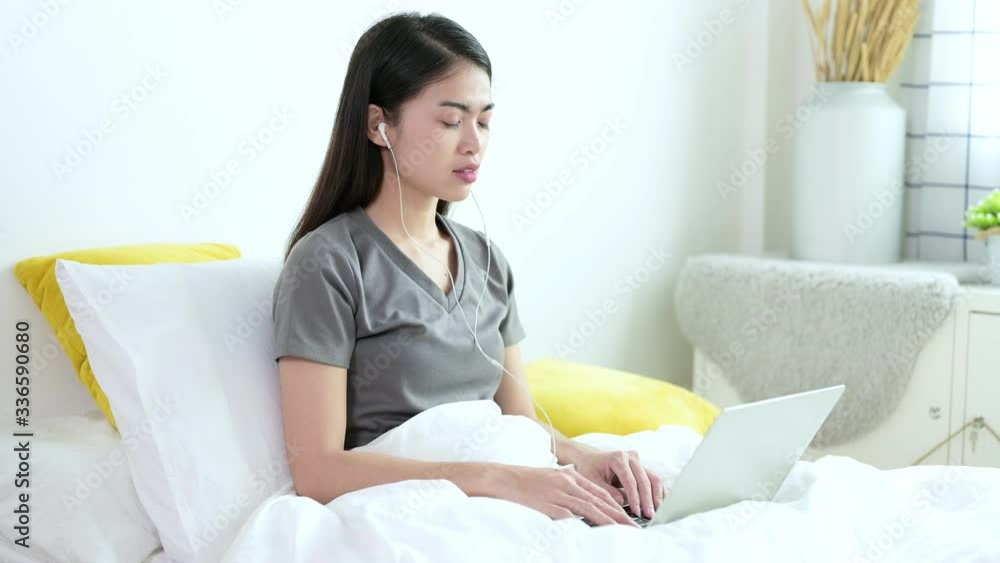 Beautiful young asian woman in grey T-shirt are video calling by laptop with her friend, family or boyfriend for social distancing policy. Self quarantine, coronavirus, work from home concept Beautiful young asian woman in grey T-shirt are video calling by laptop with her friend, family or boyfriend for social distancing policy. Self quarantine, coronavirus, work from home concept