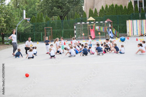Group of children warming up and preparing for the main part of lesson.  Sport school