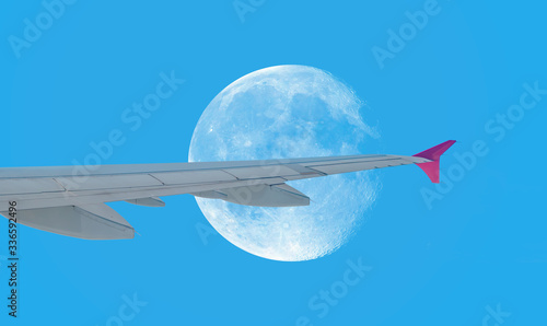 Passenger airplane flying view from inside window aircraft of traveling with full moon   Elements of this image furnished by NASA 