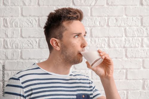 Young man with milk on whit...