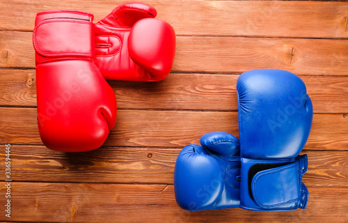 red and blue boxing gloves on wooden boards