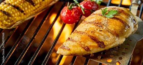 Healthy low fat chicken breast on a BBQ fire photo