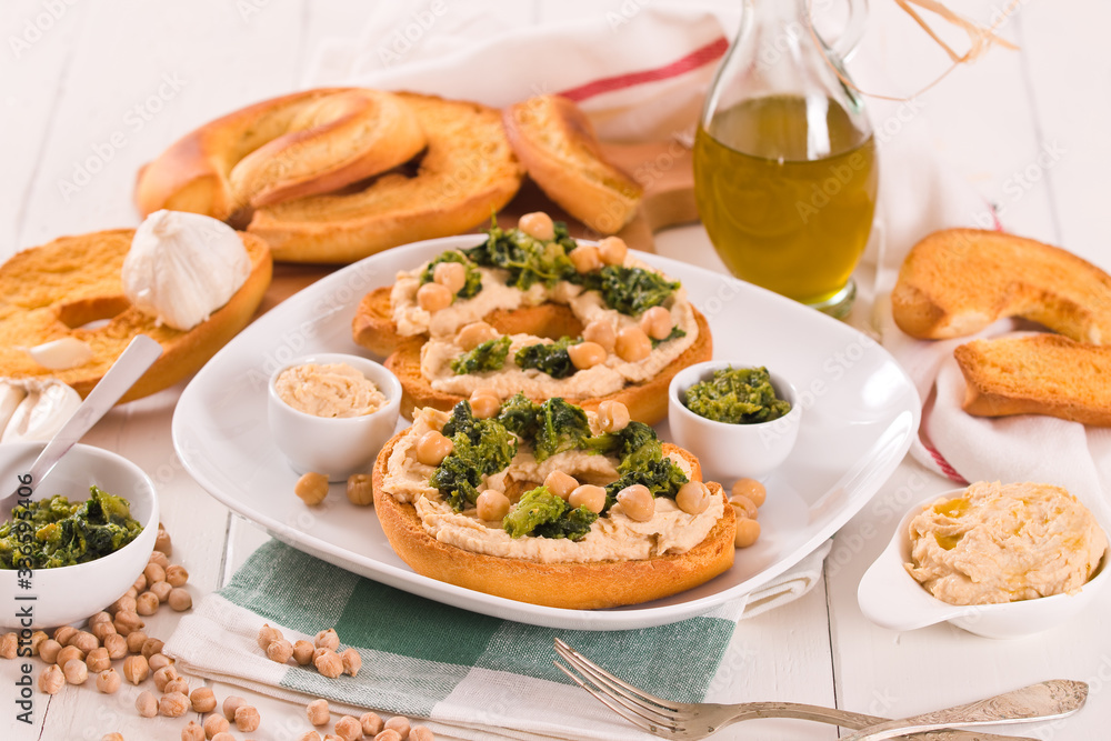 Friselle with turnip tops and hummus.
Friselle with turnip tops and hummus.