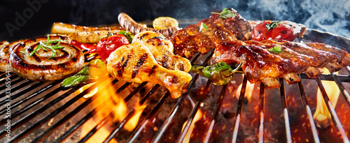 Panorama banner of assorted meat grilling on a BBQ