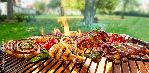 Assorted of mixed meats on a BBQ grill photo
