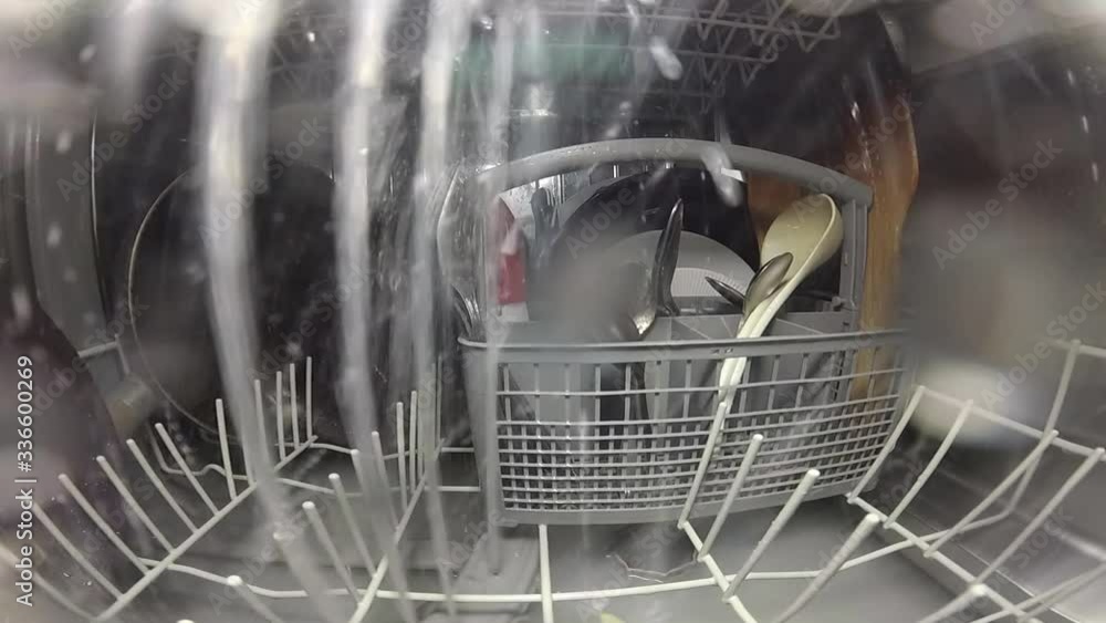 Slow motion. The master repairs the dishwasher and checks the operation